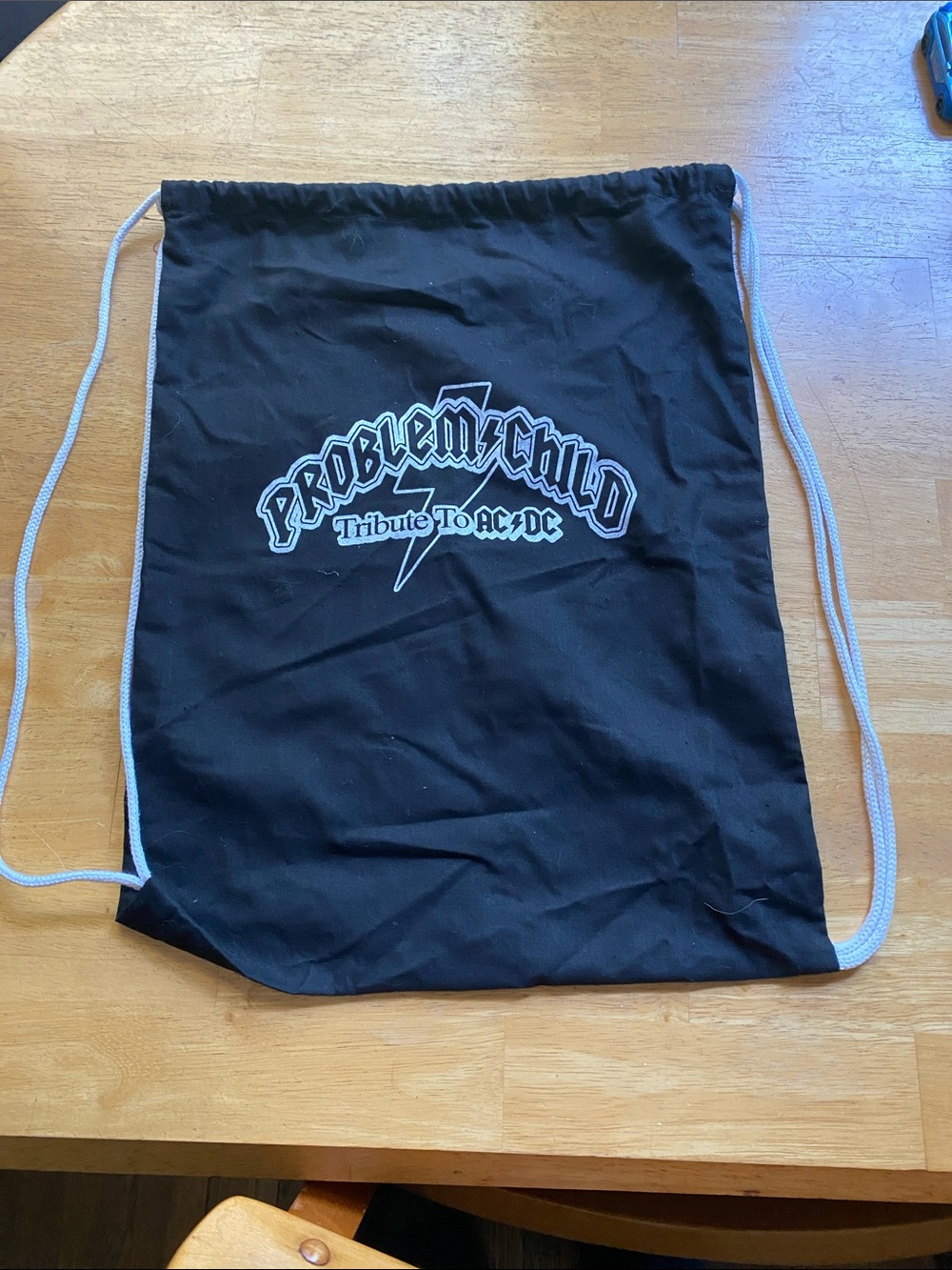 The black drawstring backpack featuring the logo for Problem Child,